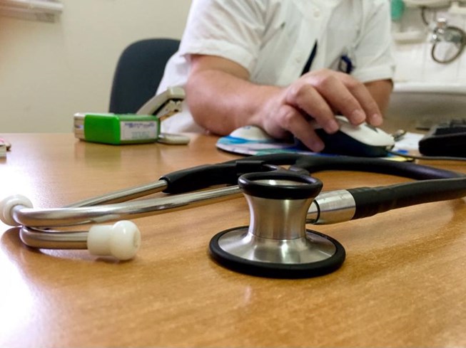 A physician looking at evidence-based guidelines on his computer.