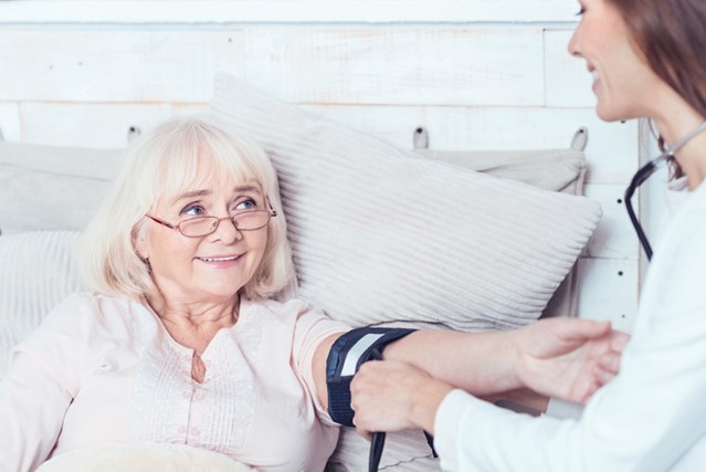 Female doctor provides palliative care to baby boomer.